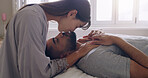 Couple, love and kiss in bed, room and romance of intimacy, special moment and bonding together at home. Young man, woman and kissing partner for happy relationship, honeymoon and care in the morning