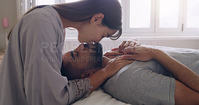 Buy stock photo Couple, love and kiss in bed, room and romance of intimacy, special moment and bonding together at home. Young man, woman and kissing partner for happy relationship, honeymoon and care in the morning