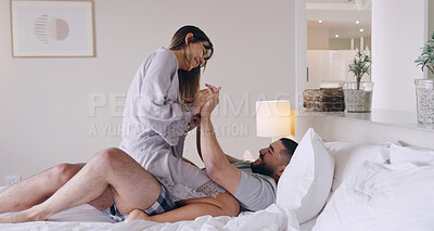 Buy stock photo Couple, love and playful in bed, room and romance of special moment, relaxing and bonding together at home. Young man, woman and laughing for happy relationship, fun honeymoon and care in the morning