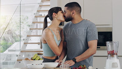 Buy stock photo Love, cooking and couple kissing in kitchen while preparing a healthy, fresh and diet breakfast. Happy, bonding and young man and woman with intimate moment while cutting fruit for smoothies together