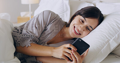 Buy stock photo Happy, woman and texting on cellphone in bedroom for online dating app, reading social media notification and relax. Female typing on smartphone in bed, morning and mobile internet download at home