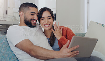 Buy stock photo Engagement, announcement and a couple on a video call from a sofa in the living room of their home together. Smile, proud or excited with a happy man and woman sharing good news about their marriage