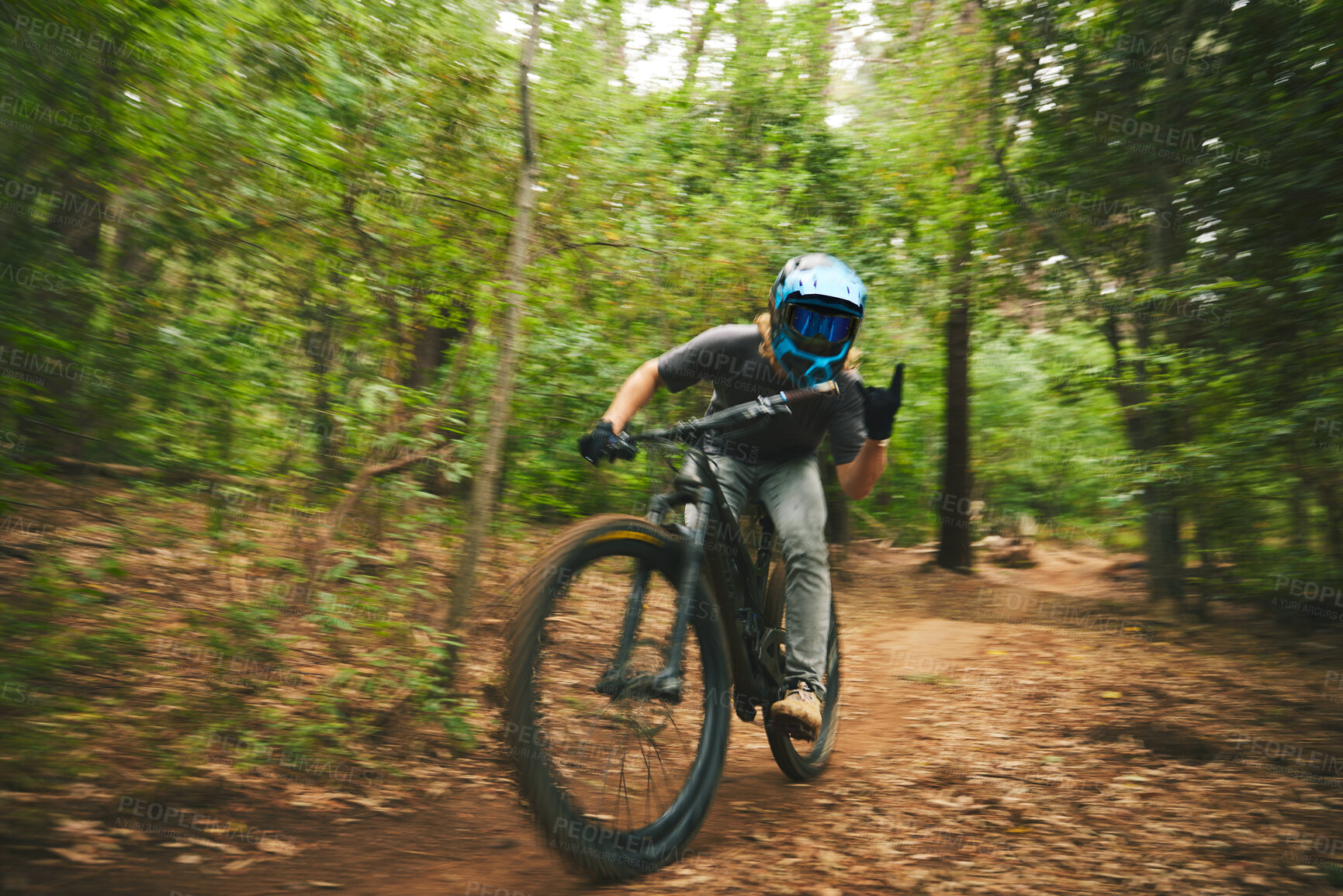 Buy stock photo Mountain bike, man and rock on sign of freedom, adventure and speed of motion blur in forest. Bicycle athlete, extreme sports and hands of horn gesture for action, off road competition and adrenaline