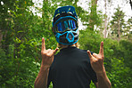 Rocker, man and biker with helmet, horn sign and fun attitude for cycling adventure in forest. Portrait of cyclist with rock on hand gesture, emoji and freedom for sports action in mountains outdoor