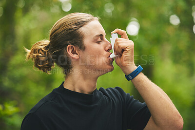 Buy stock photo Man breathe asthma pump outdoor in garden, park and help with health risk, cough treatment and stress of exercise. Male runner breathing medicine inhaler in nature for lungs, oxygen or allergy relief