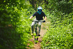 Man, mountain bike and extreme sports in forest for adventure, speed and power in park. Athlete, freedom and bicycle race for outdoor action, off road fitness and gear of cardio competition in nature