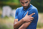 Sports, fitness and man with pain in shoulder after workout, exercise and marathon training outdoors. Medical emergency, health and male person with muscle strain, arm injury and joint ache in park