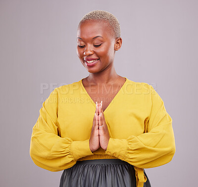 Buy stock photo Hands together, smile and black woman with prayer, hope and religious belief against a grey studio background. Female person, worship and model with hand gesture, happiness and faith with wellness