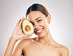 Woman, skincare and avocado in studio portrait for health, wellness or facial glow by white background. Girl, model and healthy skin with fruit, makeup or cosmetics for self care, aesthetic and smile