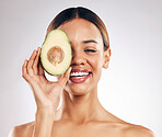 Skincare, smile and woman with avocado in studio for organic, facial or treatment on grey background. Face, avo and girl model with fruit for eco, vegan or skin detox with anti aging or antioxidants