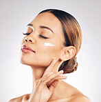 Skincare, face cream and woman relax in studio for cosmetic, wellness or self love on grey background. Facial, beauty and female model with sunscreen, moisturizer or collagen mask for hydration