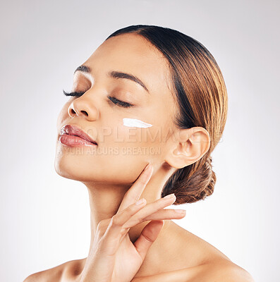 Buy stock photo Skincare, face cream and woman relax in studio for cosmetic, wellness or self love on grey background. Facial, beauty and female model with sunscreen, moisturizer or collagen mask for hydration