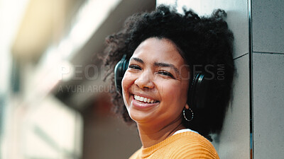 Buy stock photo Woman, headphones and music in portrait, city and street with smile, sound tech and freedom. African girl, audio streaming subscription and happy outdoor for listening, hip hop or radio in metro road