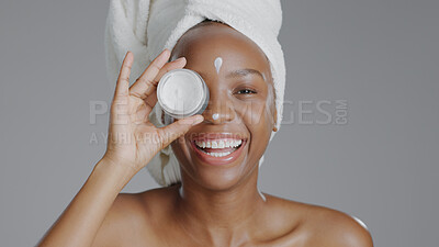 Buy stock photo Black woman, face and cream, fun and laugh, beauty portrait and moisturizer container isolated on studio background. Happy female, towel and skincare with lotion, cosmetic product and playful