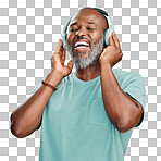 Happy mature African American man standing alone against isolated on a png background in a studio and wearing headphones to listen to music. Smiling portrait of senior black man with grey beard enjoying music