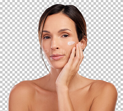Buy stock photo Shot of an attractive young woman applying moisturiser to her face in the studio