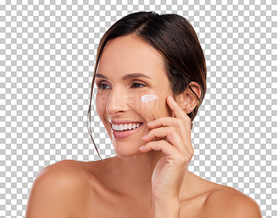 Buy stock photo Shot of an attractive young woman applying moisturiser to her face in the studio