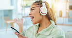 Woman with smartphone, headphones and dancing while listening to music on work break and relax in office social space. Singing along to radio, online streaming and wifi with energy, fun and rhythm