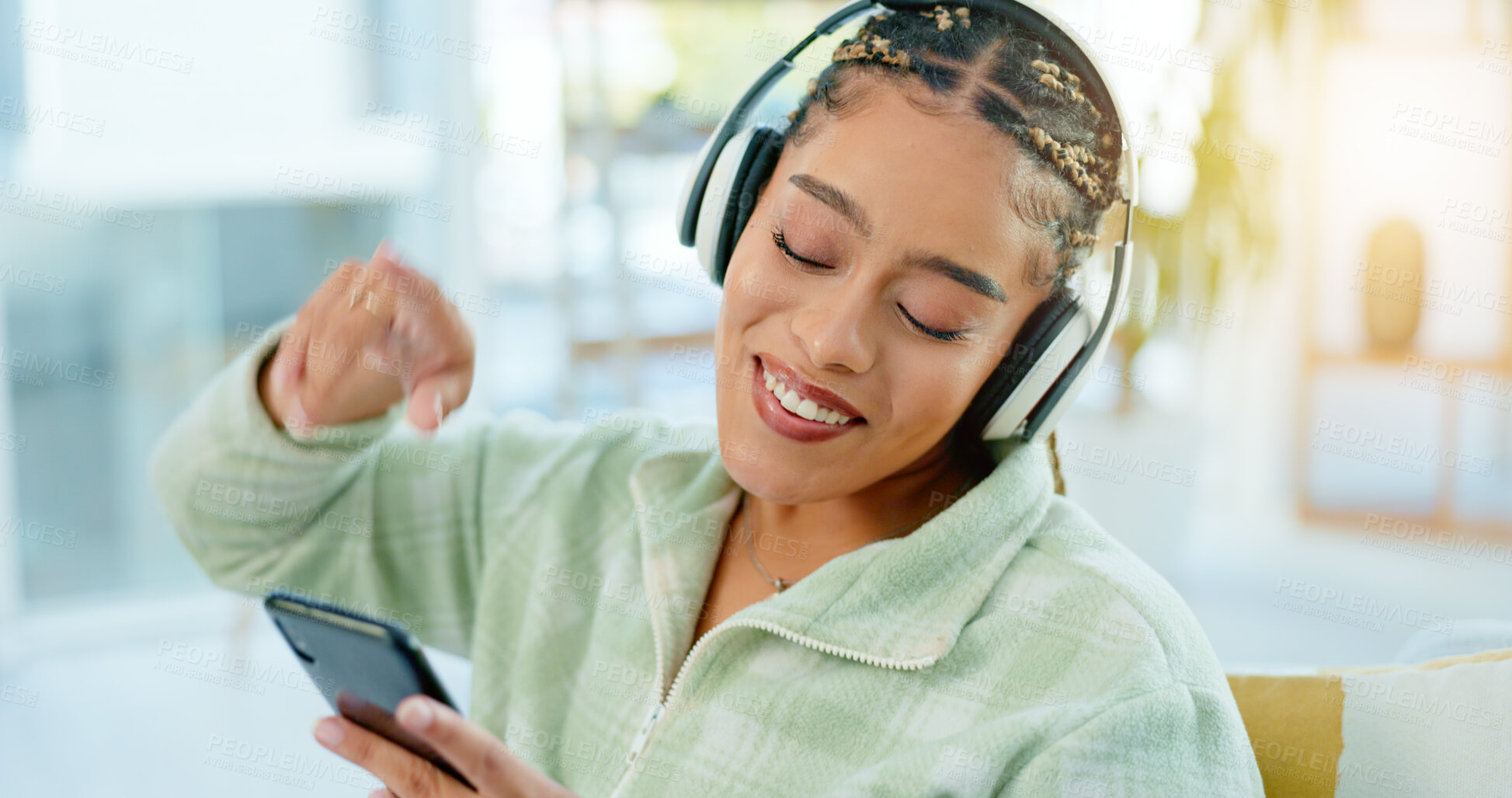 Buy stock photo Phone, dance and happy woman on music headphones in home living room. Smartphone, radio and African person listening to podcast, audio and sound for freedom, celebration and streaming media online