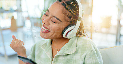 Buy stock photo Phone, dance and happy woman on music headphones in home living room. Smartphone, radio and excited African person listening to podcast, audio and sound for freedom, celebration and streaming online