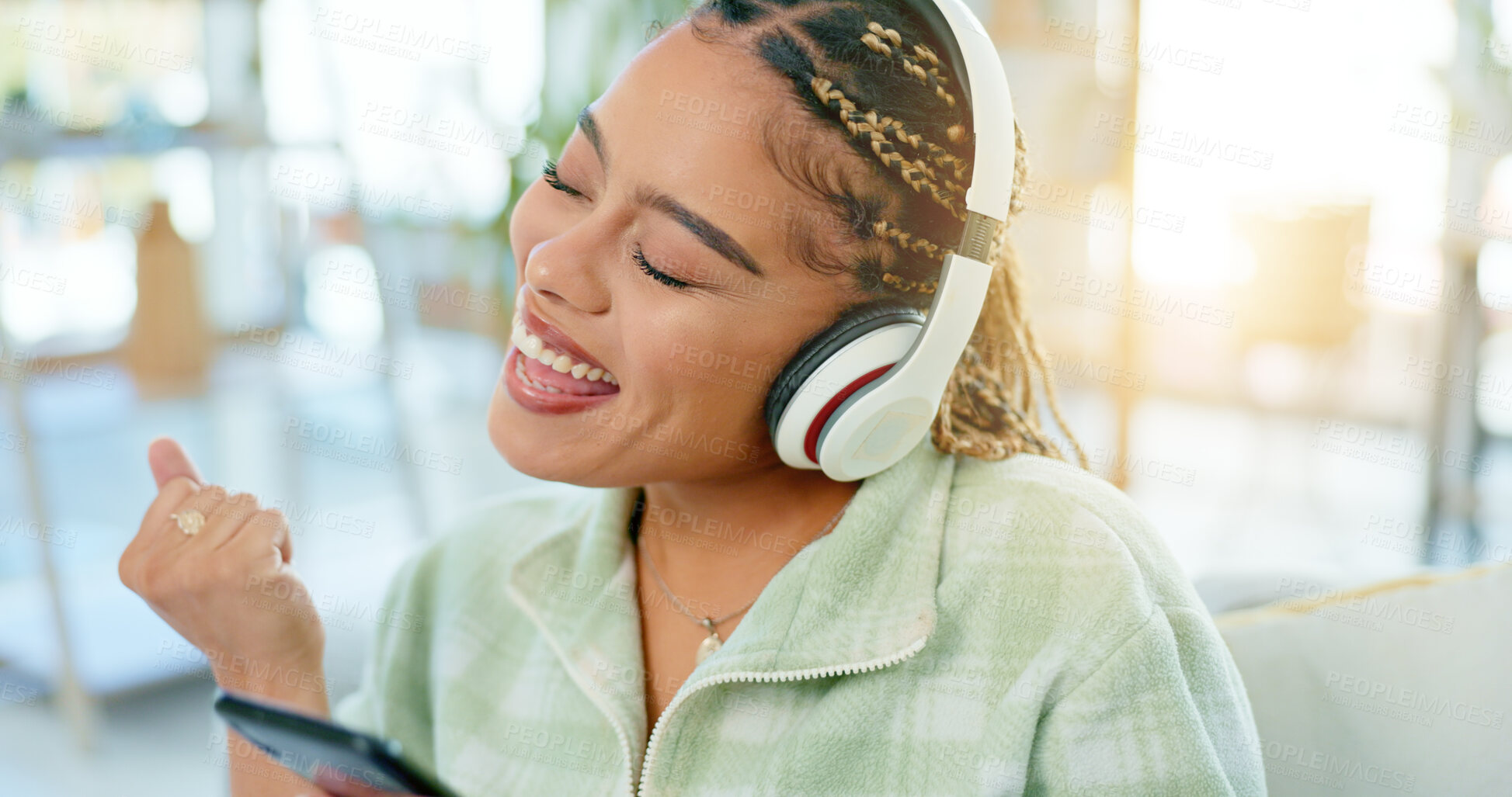 Buy stock photo Phone, dance and happy woman on music headphones in home living room. Smartphone, radio and excited African person listening to podcast, audio and sound for freedom, celebration and streaming online