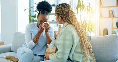 Buy stock photo Sad, empathy and support with black woman friends on a sofa in the living room of a home together. Depression, mental health and a young person crying into a tissue during loss, pain or grief