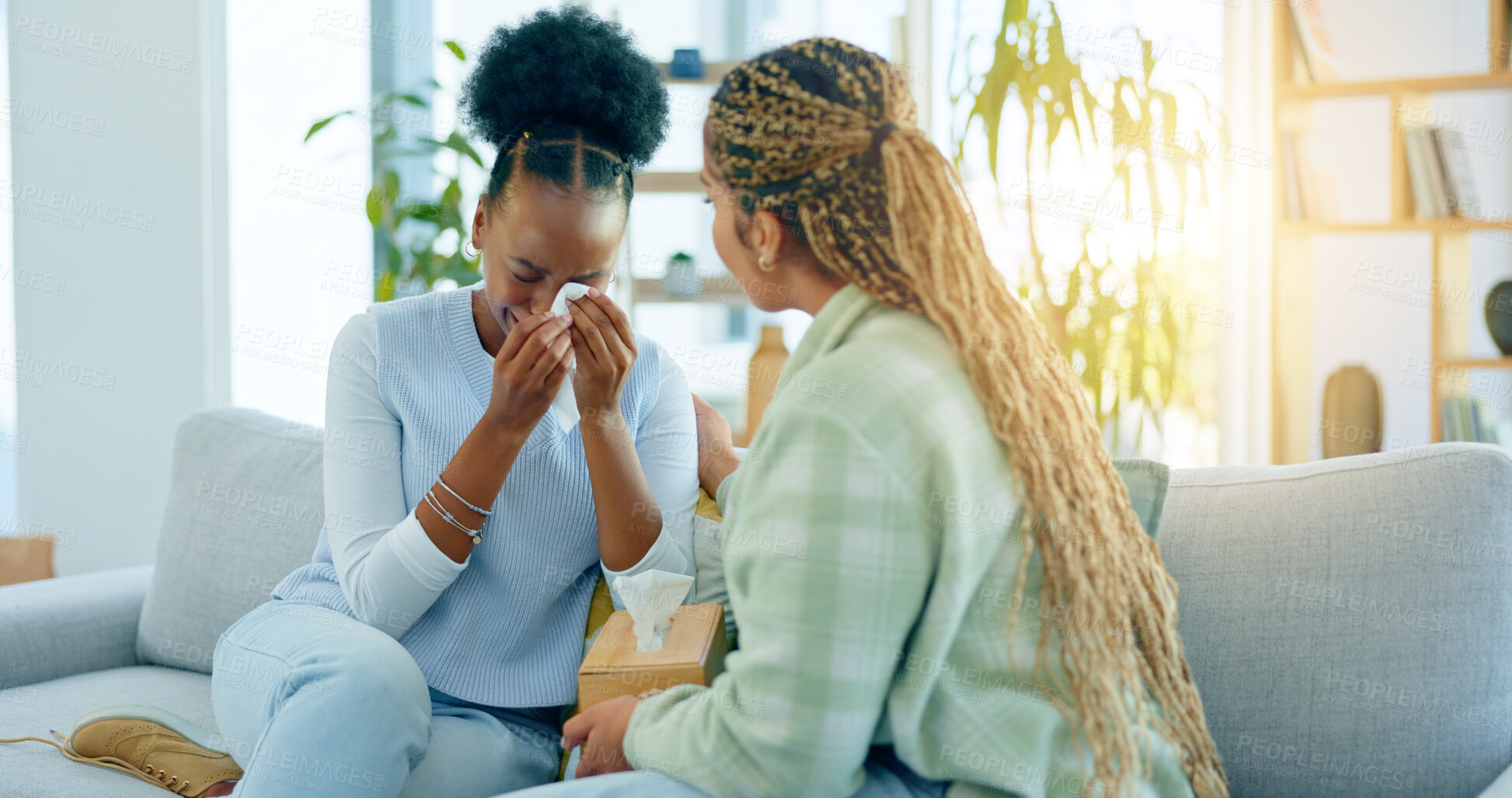 Buy stock photo Sad, empathy and support with black woman friends on a sofa in the living room of a home together. Depression, mental health and a young person crying into a tissue during loss, pain or grief