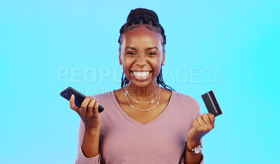 Black woman, credit card and smartphone for online shopping, retail and payment with lady against a blue studio background. Nigerian female customer, client and shopper with cellphone and ecommerce