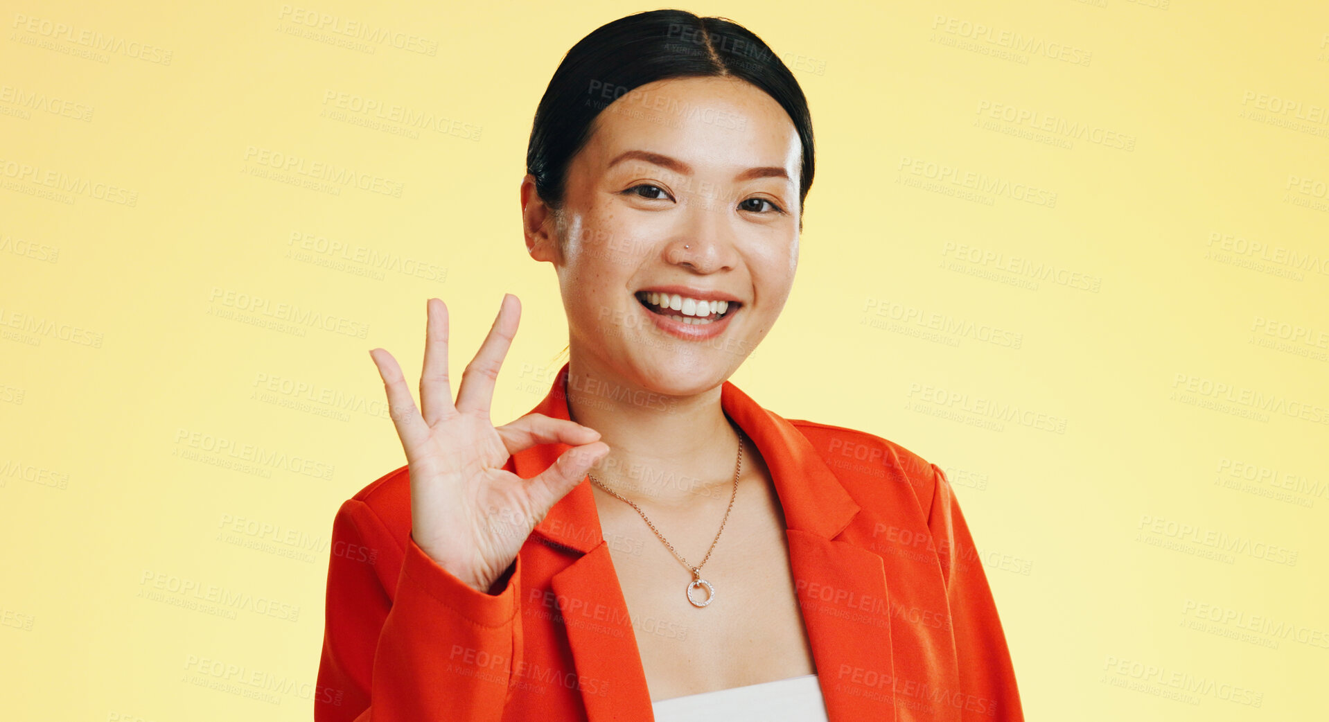 Buy stock photo Happy woman, okay hands and perfect, agreement or business excellence on a yellow, studio background. Portrait of asian employee with success, achievement or yes emoji for career vote or job feedback