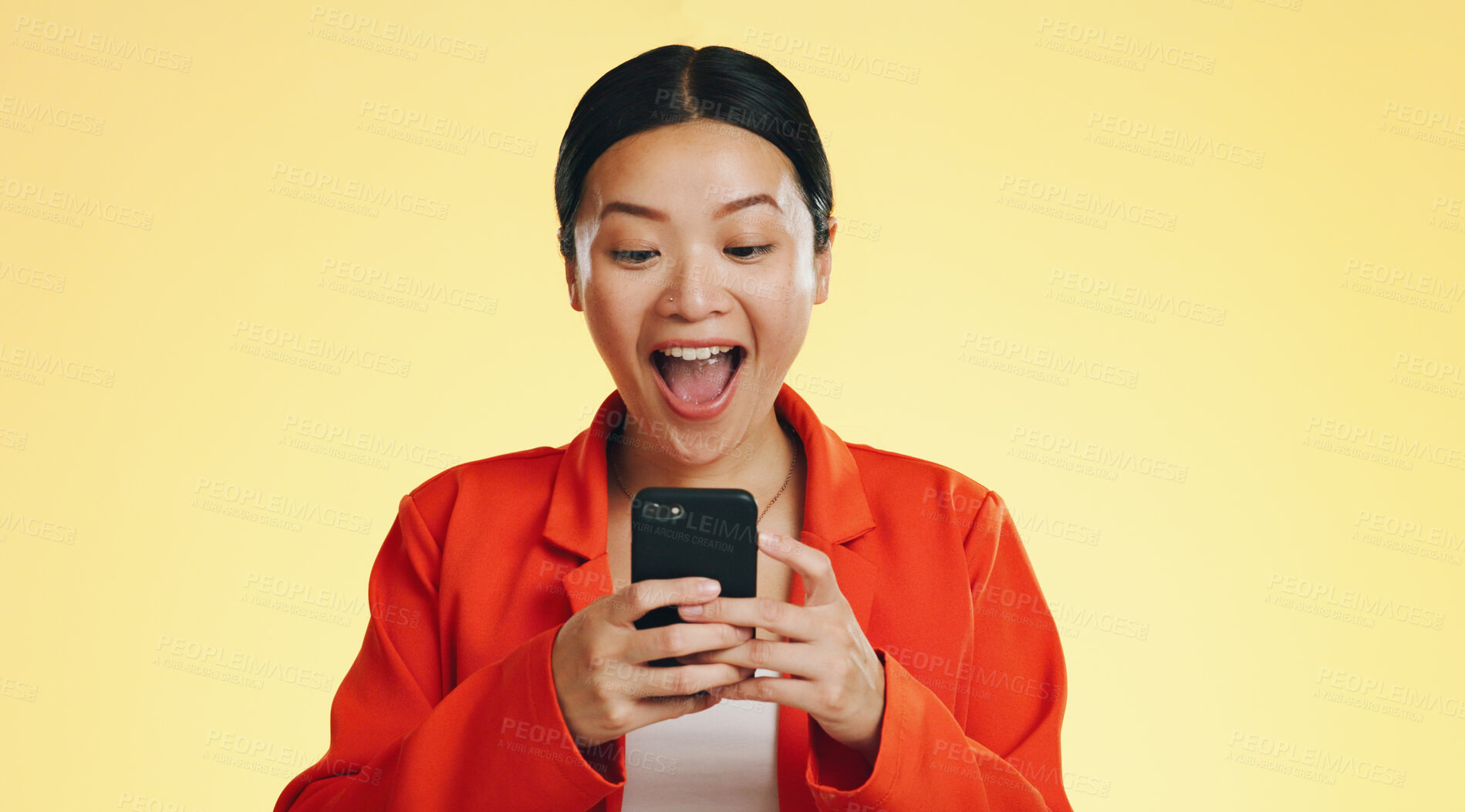 Buy stock photo Woman, winner and wow or phone success, celebration and excited for opportunity, social media competition or news in studio. Asian person scream for bonus notification on mobile and yellow background