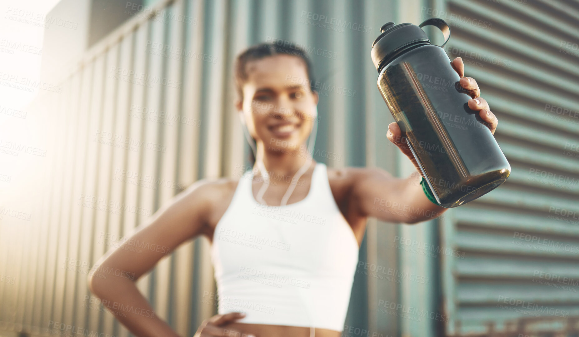 Buy stock photo Earphones, runner or happy woman with bottle in city to hydrate or relax on exercise or water break. Tired blur, thirsty or portrait of girl with liquid for hydration in fitness training or workout 