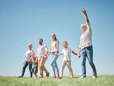 Buy stock photo Family, walk and nature together with field, grass and sunshine while on vacation. Mom, dad and children walking in green woods or park in spring, plants and countryside with happy big family