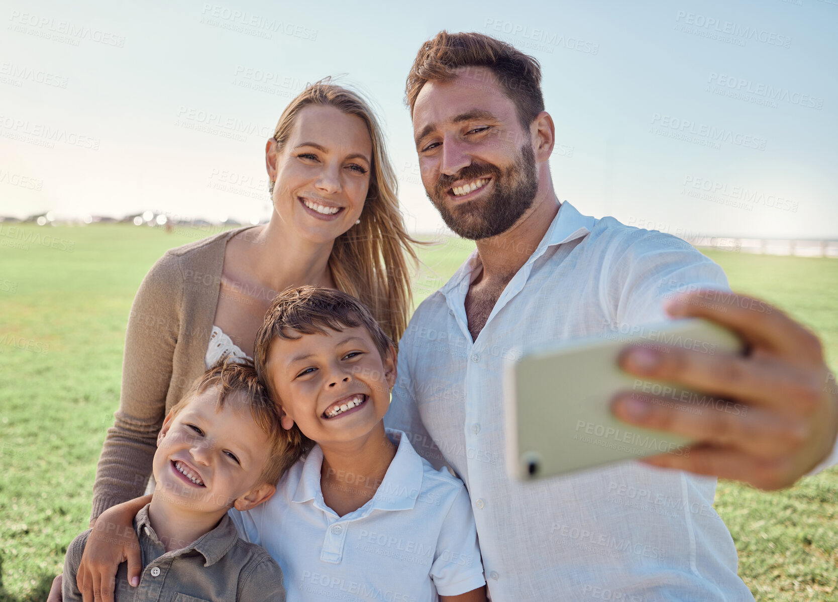 Buy stock photo Nature, selfie and phone with happy family social media picture on a holiday together in outdoor green garden. Happy, smile and parents smile, photo and love bonding with children outside in a park 
