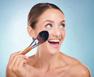 Buy stock photo Woman, smile and makeup brush in studio for cosmetic self care, beauty or happy by blue background. Model, happiness and cosmetics brush and self love, skin wellness or foundation on face by backdrop