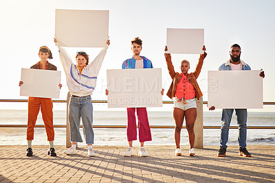 Buy stock photo Portrait, poster and diversity with friends together holding signage in protest on the promenade by the sea. Freedom, mockup and billboard with a man and woman friend group holding blank sign boards