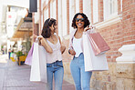 Friends in the city, shopping bag and happiness with retail, fashion and women at outdoor market. Shop at boutique, designer brand and happy customer, discount and sale with laughter in Paris