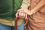Closeup, hands and couple with support, cane and retirement with solidarity, marriage or appreciation. Zoom, touching or senior man with old woman, love or care with empathy, understanding or comfort