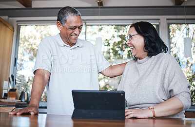 Buy stock photo Happy, laughing and senior couple with digital tablet in a kitchen, relax and bonding in their home. smile, laugh and old people enjoying retirement, joke and fun while browsing online in their house