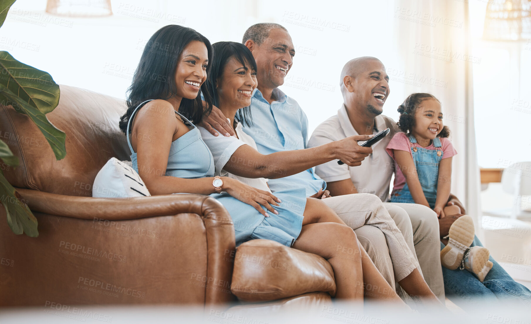 Buy stock photo Happy, TV and family on sofa with remote for bonding, quality time and relaxing in living room. Grandparents with mother, father and child on couch streaming comedy movies, entertainment and series