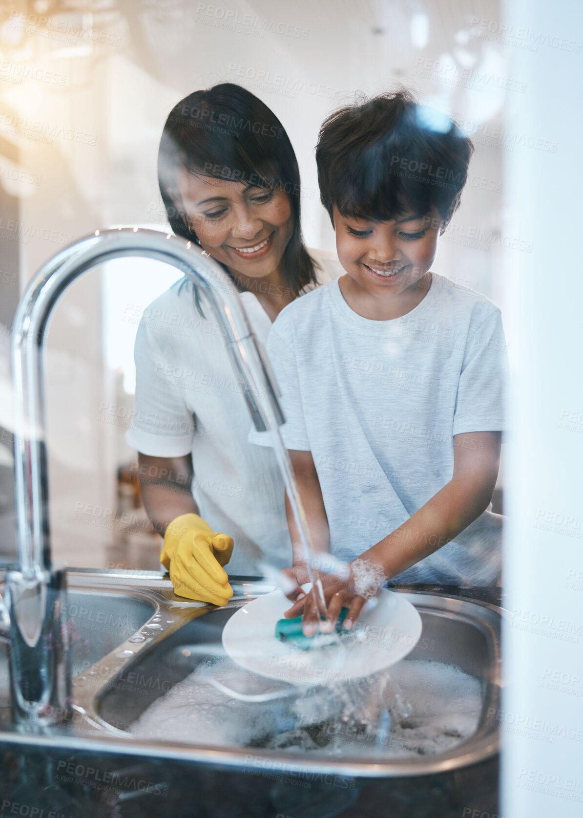 Buy stock photo Woman, boy child and dishes at kitchen sink for learning, cleaning and hygiene with care in family house. Mother, boy and washing play with soap, water and teaching for skills, chore or stop bacteria