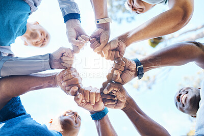 Buy stock photo Fist bump, fitness and group of people for teamwork, collaboration and community, team building and support. Mission, workout goals and hands, power and solidarity sign of person outdoor from below