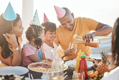 Buy stock photo Birthday, parents and children with juice by beach for event, celebration and outdoor party together. Family, social gathering and mother, dad and kids at picnic with cake, presents and eating food