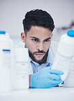 Laboratory, man or scientist reading container at pharmaceutical laboratory checking stock or info on cure. Research, bottle label or science researcher in manufacturing job with chemical inventory 