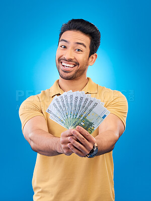 Buy stock photo Cash, portrait and happy man or winner for bonus offer, financial success and winning, finance loan or lottery fan. Young asian person with savings, money or profit isolated on studio blue background