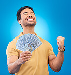 Money, studio and man excited, cheers and smile for dollar bills, financial achievement award or bonus prize. Cash, competition winner and person happy for income, revenue or pay on blue background