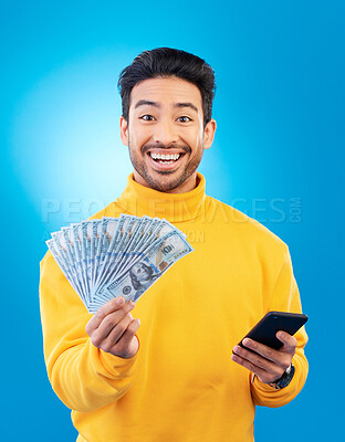 Buy stock photo Man, phone and cash fan in studio for prize, esports gambling or excited in portrait by blue background. Young asian guy, winner and smartphone for money, fintech or crypto with profit, bonus or goal