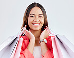 Customer, portrait or happy woman with shopping bags for retail sale, store offer or discount deal. Choice, face or girl shopper holding gifts, present or product on promotion on white background 