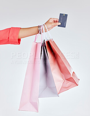Buy stock photo Credit card, studio or hand of woman with shopping bags for retail sale, product offer or discount deal. Financial, customer or girl shopper holding gifts or present on promotion on white background