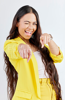Buy stock photo Portrait, pointing and wink with an excited woman in studio on a gray background to choose you. Smile, hands and selection with a happy young female model in yellow clothes to vote on a decision