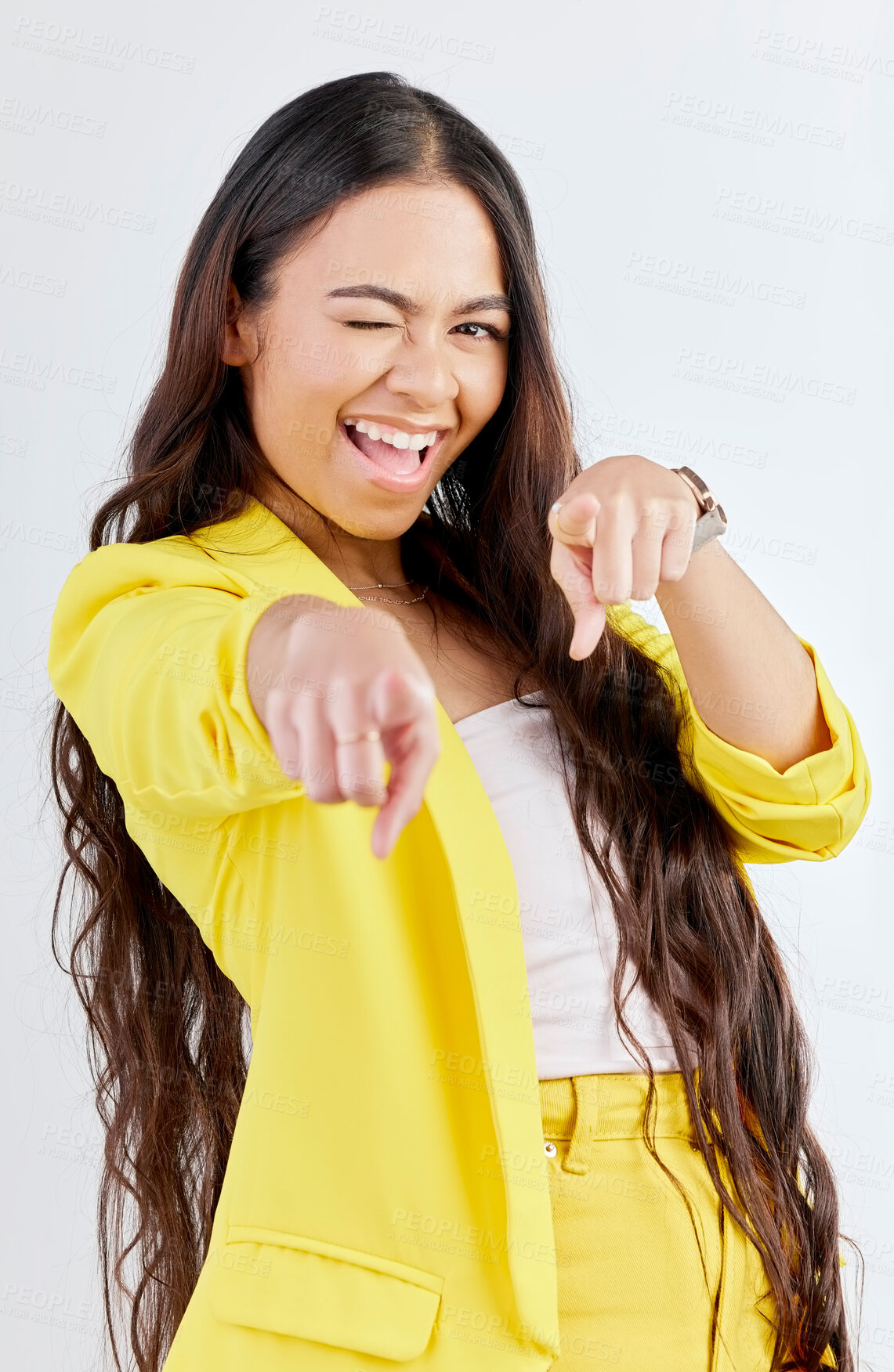 Buy stock photo Portrait, pointing and wink with an excited woman in studio on a gray background to choose you. Smile, hands and selection with a happy young female model in yellow clothes to vote on a decision